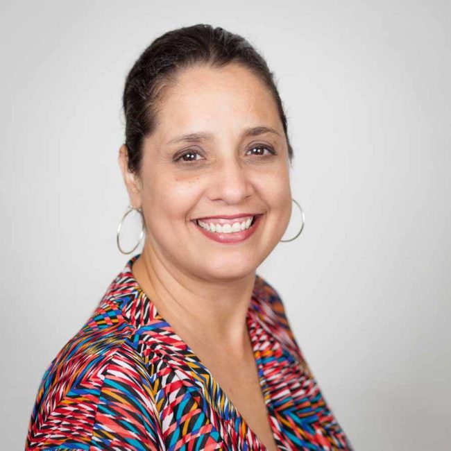 Headshot of woman with colourful blouse