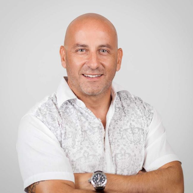 Headshot of male entrepreneur with crossed arms