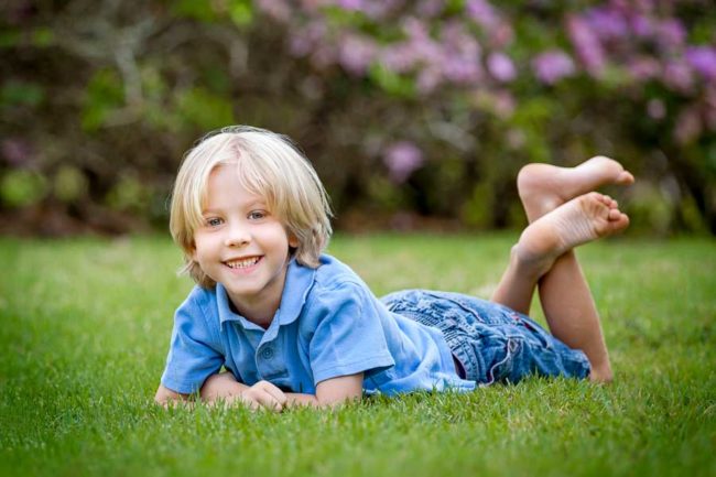 Boy laying relaxed in grass